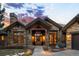 Stunning stone home featuring a welcoming front entrance with a beautiful wooden door and a meticulously maintained walkway at 1105 Northwood Ln, Castle Rock, CO 80108