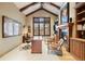 Home office featuring hardwood floors, beamed ceilings, fireplace, and built-in bookshelves at 1105 Northwood Ln, Castle Rock, CO 80108