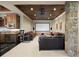 Home theater room with large screen, projector, wet bar, and comfortable seating at 1105 Northwood Ln, Castle Rock, CO 80108