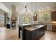 Spacious kitchen with custom cabinets, granite countertops, and a fireplace, perfect for cooking and entertaining at 1105 Northwood Ln, Castle Rock, CO 80108