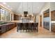 Gourmet kitchen with custom cabinetry, granite countertops, stainless steel appliances, and a large central island with seating at 1105 Northwood Ln, Castle Rock, CO 80108