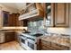 Close-up of the gourmet kitchen featuring granite countertops, custom cabinetry, and professional-grade stainless steel appliances at 1105 Northwood Ln, Castle Rock, CO 80108