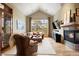 Cozy living room with vaulted ceilings, a fireplace, comfortable seating, and a large window with natural light at 1105 Northwood Ln, Castle Rock, CO 80108