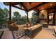 Relaxing outdoor deck with fireplace, vaulted ceiling, and lounge seating overlooking wooded views at 1105 Northwood Ln, Castle Rock, CO 80108