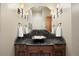 Powder room with a unique dark stone countertop and decorative lighting at 1105 Northwood Ln, Castle Rock, CO 80108
