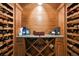 Custom wine cellar with wooden racks, storage, granite countertop, and a decorative layout for wine enthusiasts at 1105 Northwood Ln, Castle Rock, CO 80108