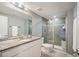 Stylish bathroom with gray walls, granite counters, and a walk-in shower with glass doors and tiled walls at 2746 Geneva St, Denver, CO 80238