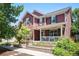 Charming two-story home featuring a welcoming front porch, complemented by a beautifully landscaped yard at 2746 Geneva St, Denver, CO 80238