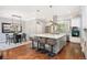 Spacious eat-in kitchen featuring a central island, stainless steel appliances, and modern pendant lighting at 2746 Geneva St, Denver, CO 80238