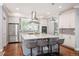 Modern kitchen featuring a large island with seating, stainless steel appliances, and designer finishes at 2746 Geneva St, Denver, CO 80238