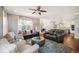 Inviting living room featuring hardwood floors, an open layout, and seamless flow to kitchen and dining at 2746 Geneva St, Denver, CO 80238