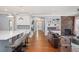 Open-concept living area showcasing a fireplace, built-in shelving, and seamless flow into kitchen at 2746 Geneva St, Denver, CO 80238