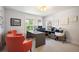 Bright office space with large desk, two windows, comfortable armchairs, and natural lighting at 2746 Geneva St, Denver, CO 80238
