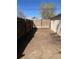 The backyard features a private, gated area surrounded by wooden fencing and side yard access at 325 N 7Th Ave, Brighton, CO 80601