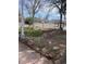 Outdoor garden area with stone benches, landscaping, and surrounding trees at 325 N 7Th Ave, Brighton, CO 80601