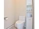 Modern bathroom featuring a toilet and a storage cabinet with shelves for toiletries at 19249 E Progress Ave, Centennial, CO 80015