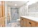 Bathroom with marbled tile, glass shower, and wood vanity cabinet at 19249 E Progress Ave, Centennial, CO 80015