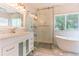 Modern bathroom with marble tile, standalone tub, glass enclosed shower, and double sink vanity at 19249 E Progress Ave, Centennial, CO 80015