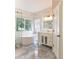Modern bathroom with marble tile, standalone tub, glass enclosed shower, and vanity with drawers at 19249 E Progress Ave, Centennial, CO 80015