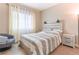 Cozy bedroom featuring a comfortable bed with an upholstered headboard and lots of natural light at 19249 E Progress Ave, Centennial, CO 80015
