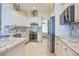 Bright kitchen with white cabinetry, stainless steel appliances, and granite countertops and backsplash at 19249 E Progress Ave, Centennial, CO 80015