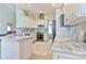 Bright kitchen with white cabinetry, stainless steel appliances, and granite countertops and backsplash at 19249 E Progress Ave, Centennial, CO 80015