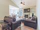 Bright living room with vaulted ceilings open to the kitchen and featuring a fireplace and hardwood floors at 19249 E Progress Ave, Centennial, CO 80015