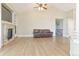 Spacious living room with a fireplace, built-in shelving, and plenty of natural light at 19249 E Progress Ave, Centennial, CO 80015