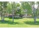 Green expansive yard with mature shade trees and wooden fencing, creating a picturesque outdoor space at 19249 E Progress Ave, Centennial, CO 80015
