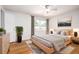 Comfortable bedroom featuring hardwood floors, large windows, and modern decor, creating a relaxing environment at 2856 Jasmine St, Denver, CO 80207