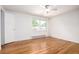 Spacious bedroom with hardwood floors, a ceiling fan, and a window letting in natural light at 2856 Jasmine St, Denver, CO 80207