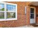 Close-up of the brick exterior and entrance, highlighting the house number and the entry door at 2856 Jasmine St, Denver, CO 80207