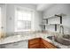 Modern kitchen area with granite countertops, stainless steel sink, and sleek fixtures with natural light at 2856 Jasmine St, Denver, CO 80207