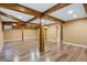 Large basement featuring exposed wood beams, wood look flooring, neutral walls and ample space at 5432 E Bails Dr, Denver, CO 80222