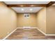 Unfinished basement featuring wood-look flooring, neutral walls and a window allowing natural light at 5432 E Bails Dr, Denver, CO 80222