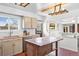 Bright kitchen features custom cabinets, butcher block counters, and a movable kitchen island at 5432 E Bails Dr, Denver, CO 80222