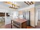 Stylish kitchen featuring a rustic wood island, stainless steel appliances, and ample storage space at 5432 E Bails Dr, Denver, CO 80222