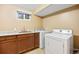 Basement laundry area features washer, dryer, and a sink with a granite countertop at 5432 E Bails Dr, Denver, CO 80222