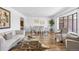 Bright living room with hardwood floors, modern furnishings, and a large bay window at 5432 E Bails Dr, Denver, CO 80222