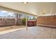 Covered outdoor patio with concrete tiles, a red shed and a brick wall with seating at 5432 E Bails Dr, Denver, CO 80222