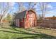 Outdoor view of a charming red shed with a white trim, shingled roof and double doors at 5432 E Bails Dr, Denver, CO 80222