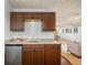 Convenient wet bar with granite countertop, cabinets and stainless steel mini fridge at 5432 E Bails Dr, Denver, CO 80222
