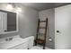 Cozy bathroom featuring a sleek vanity, minimalist design, and space-saving ladder detail at 9605 E Kansas Cir # 55, Denver, CO 80247