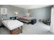 Spacious bedroom featuring a large bed, exposed brick accent wall, and a comfortable seating area at 9605 E Kansas Cir # 55, Denver, CO 80247