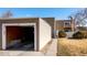 Exterior view of the home featuring a detached garage with driveway and grassy yard at 9605 E Kansas Cir # 55, Denver, CO 80247