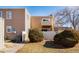 Charming home featuring an inviting exterior with a fenced yard, landscaped greenery, and a cozy balcony at 9605 E Kansas Cir # 55, Denver, CO 80247