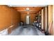 A view inside of the garage with wood paneling and open ceilings at 9605 E Kansas Cir # 55, Denver, CO 80247