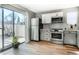 Contemporary kitchen featuring stainless steel appliances, white cabinets, and plenty of natural light at 9605 E Kansas Cir # 55, Denver, CO 80247