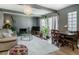 Bright and cozy living room featuring a fireplace, comfortable seating, and a welcoming table area at 9605 E Kansas Cir # 55, Denver, CO 80247
