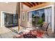 Inviting patio features comfortable seating, tiled flooring, and natural light from sliding glass doors at 9605 E Kansas Cir # 55, Denver, CO 80247